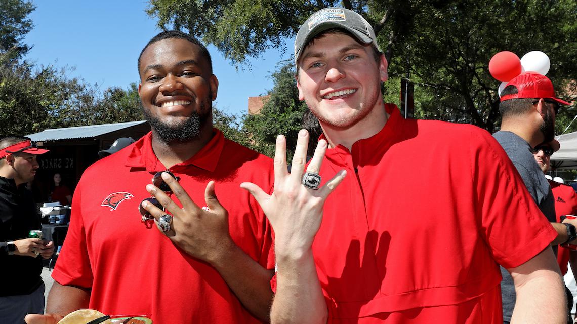 Two UIW football alumni show off their conference championship rings at Homecoming